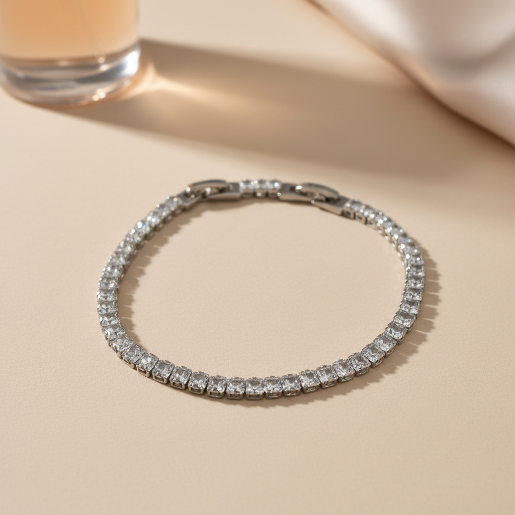 Silver bracelet with clear stones on a beige surface