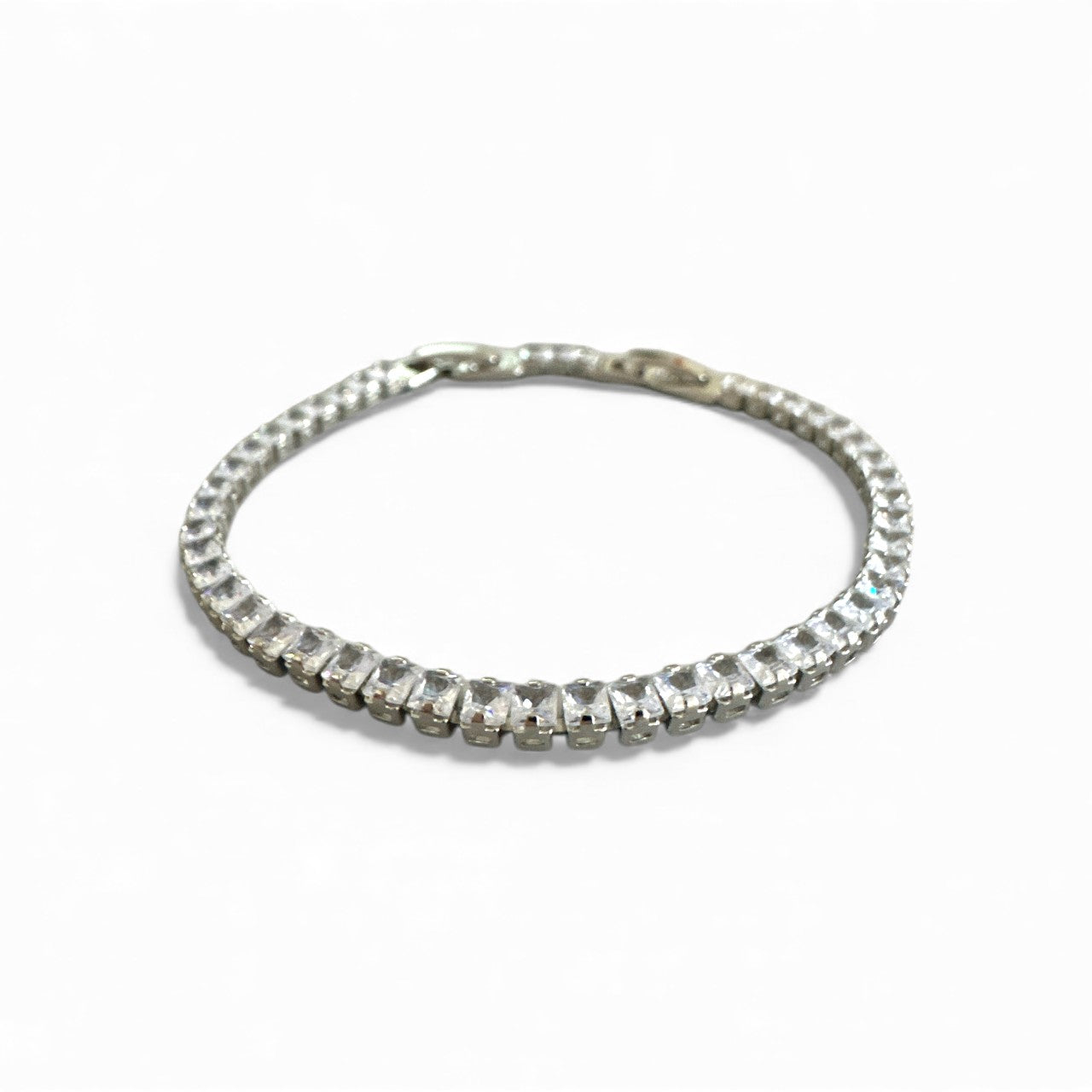 Silver bracelet with clear stones on a white background