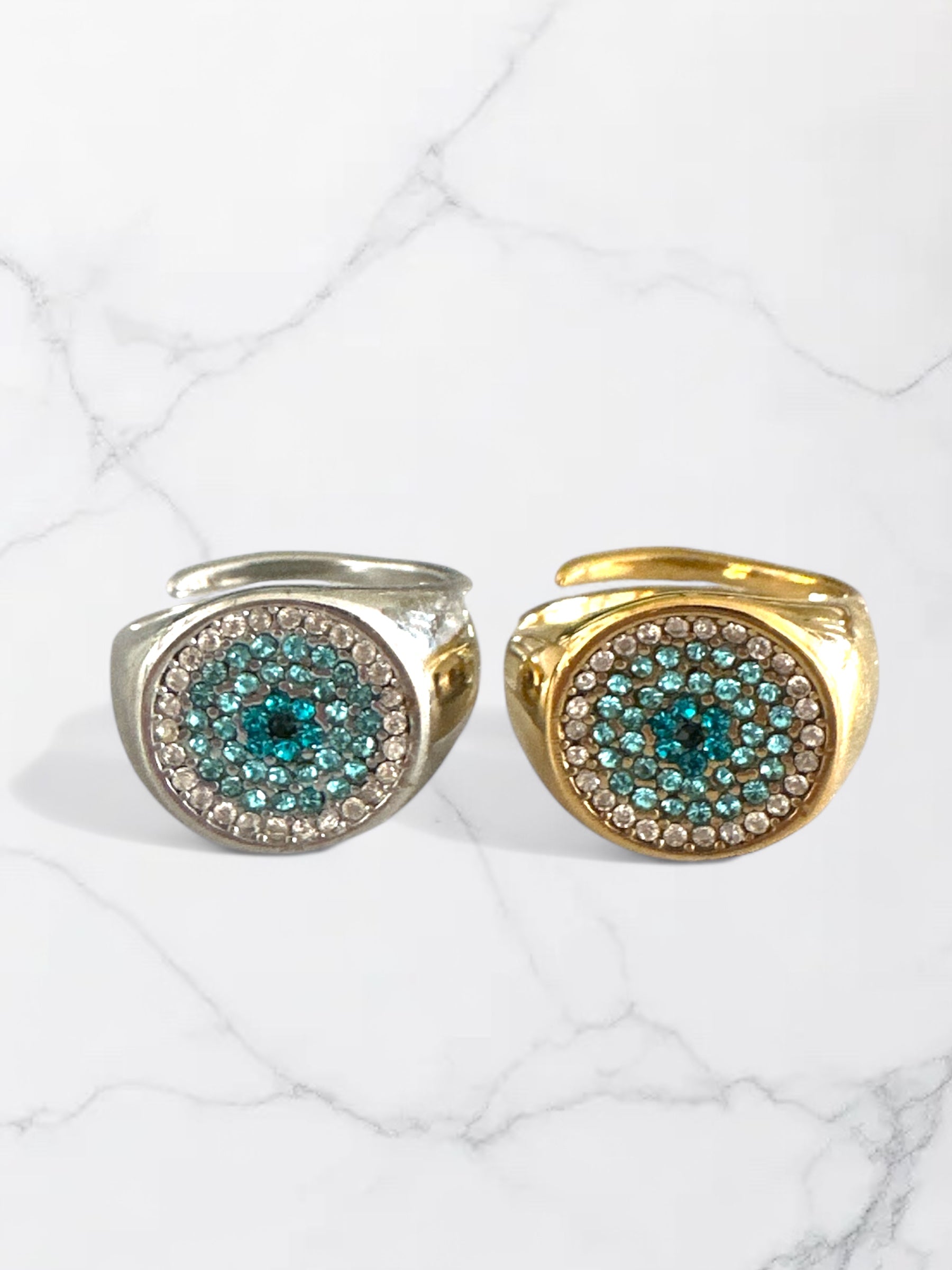 Ατσάλινα δαχτυλίδια So Cute By Dimi σε χρυσό και ασημί με κυκλικό σχέδιο και ζιργκόν σε τιρκουάζ και διάφανο χρώμα.