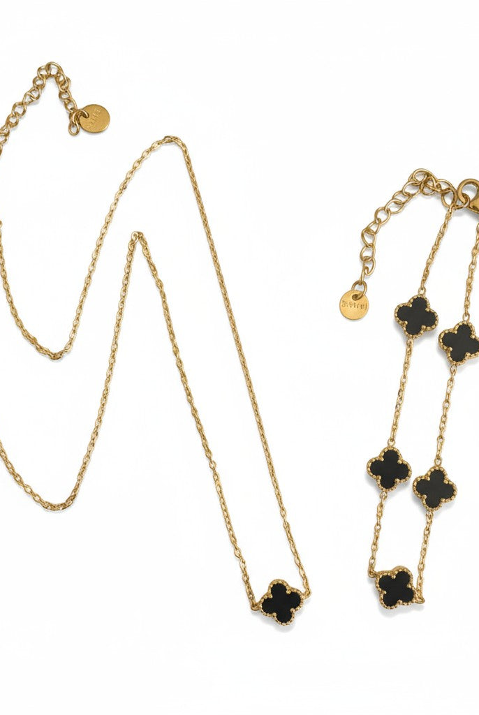 Ατσάλινο κολιέ & βραχιόλι So Cute by Dimi με χρυσή αλυσίδα και τετράφυλλο μοτίφ σε μαύρο ή λευκό φίλντισι