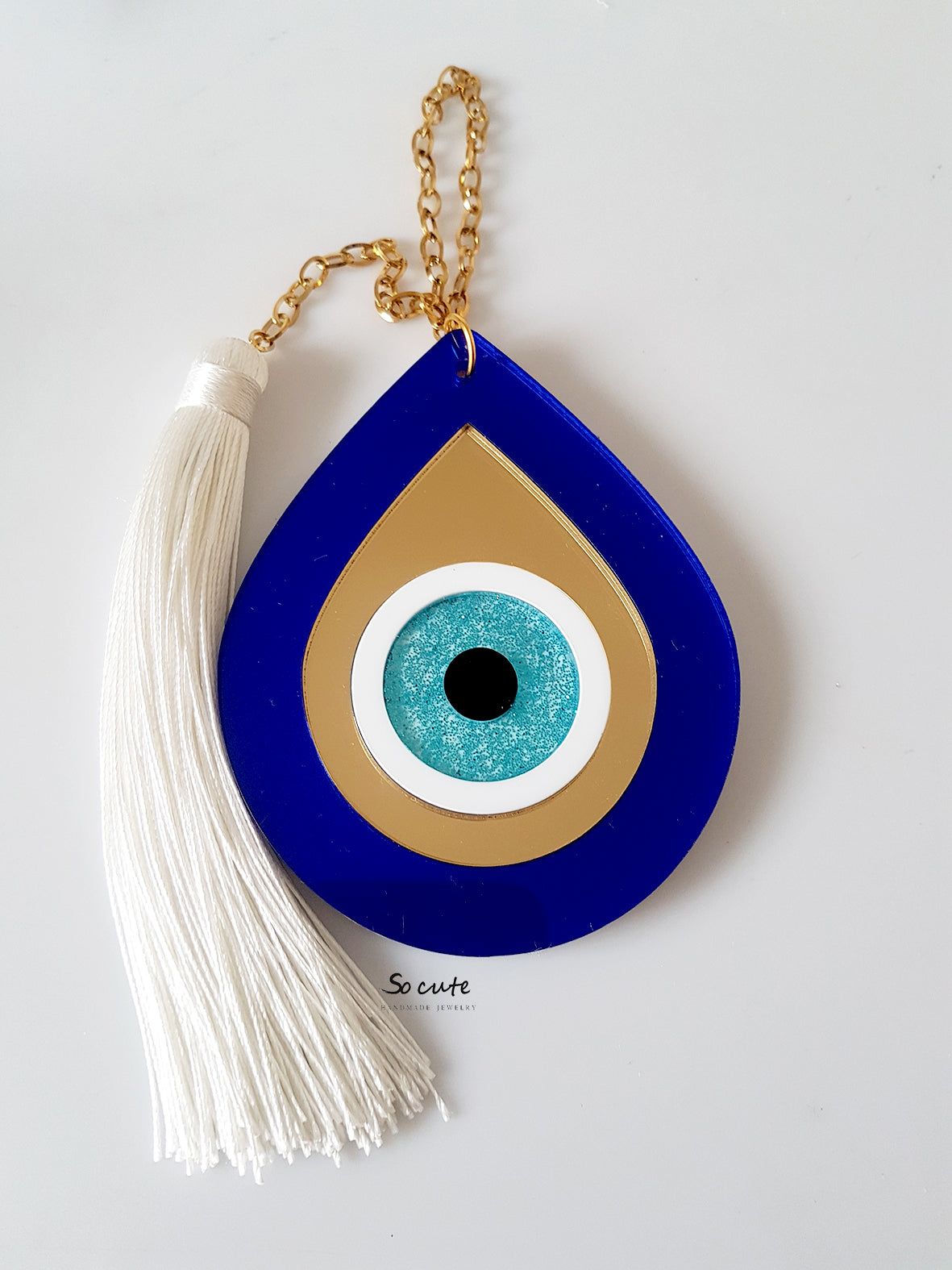 Χειροποίητο κρεμαστό γούρι μάτι σταγόνα από πλεξιγκλάς με ατσάλινη αλυσίδα και μακριά φούντα – So Cute by Dimi.