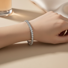 Silver bracelet with clear stones on a white background