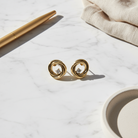 Stainless steel twisted stud earrings with central crystal in  gold – So Cute by Dimi.