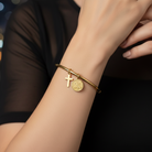 Ατσάλινο bangle σε gold με κρεμαστό σταυρό και κωνσταντινάτο – So Cute by Dimi