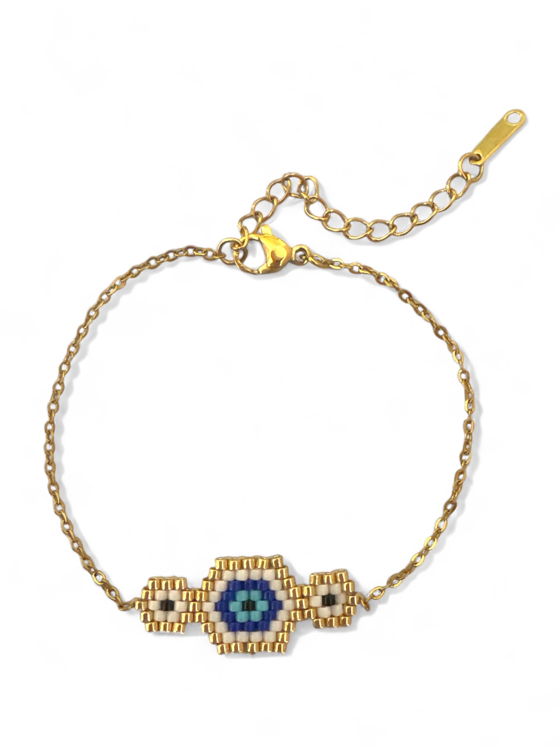 Gold bracelet with a blue eye design on a white background