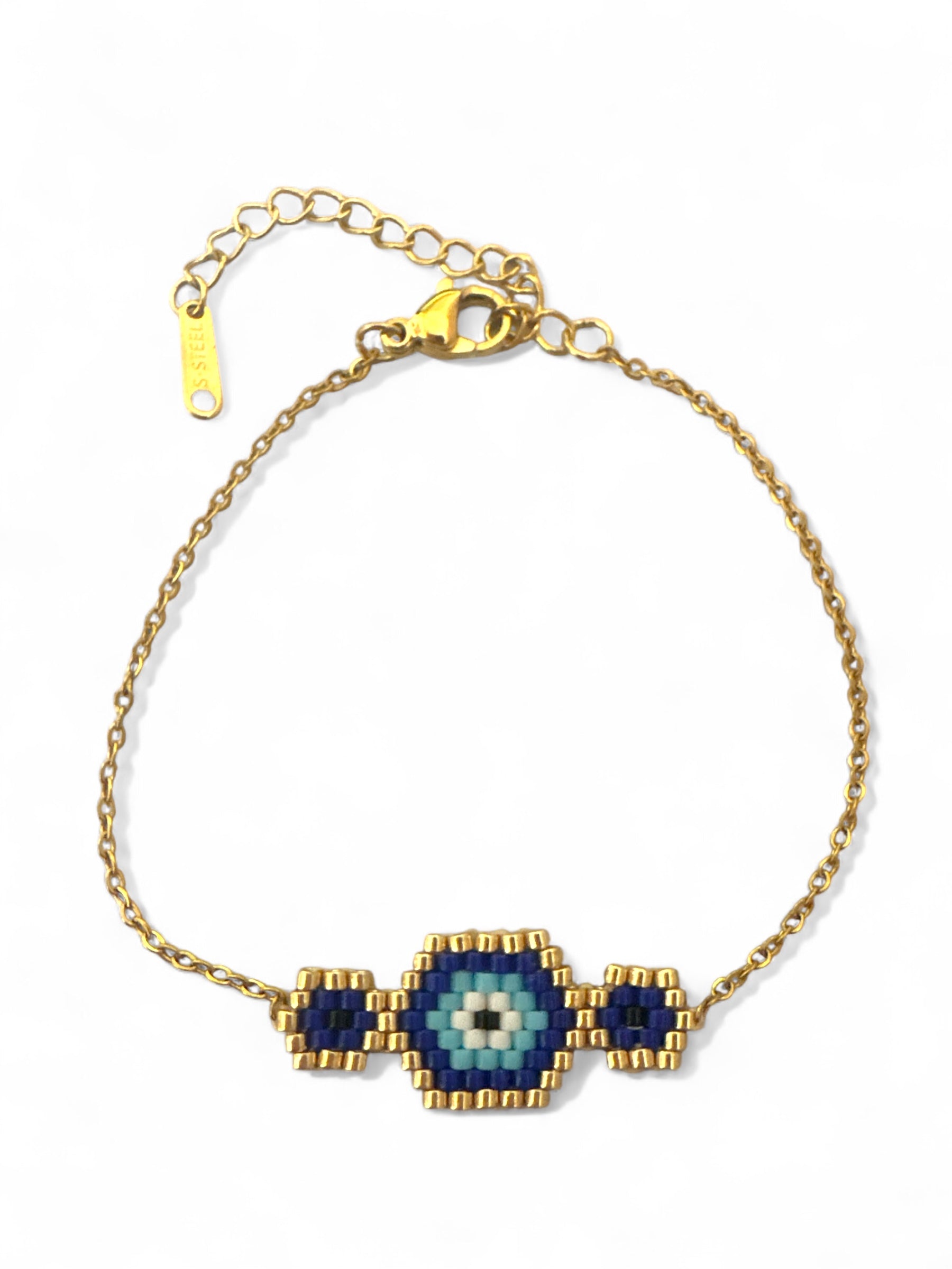Gold bracelet with blue and green eye-shaped beads on a white background