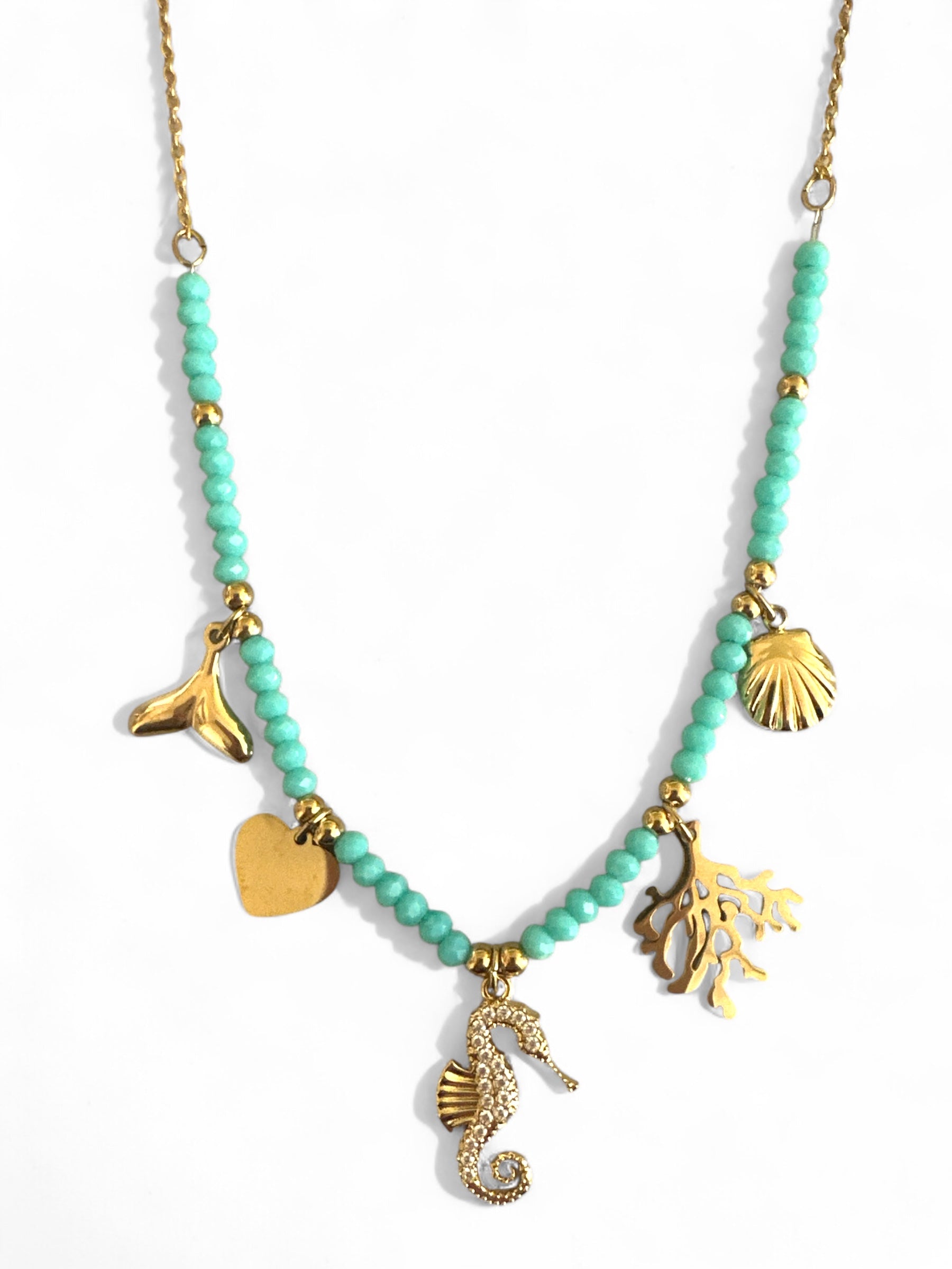 Necklace with turquoise beads and gold charms on a white background So Cute by DImi