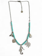 Necklace with turquoise beads and silver charms on a white background So Cute by DImi
