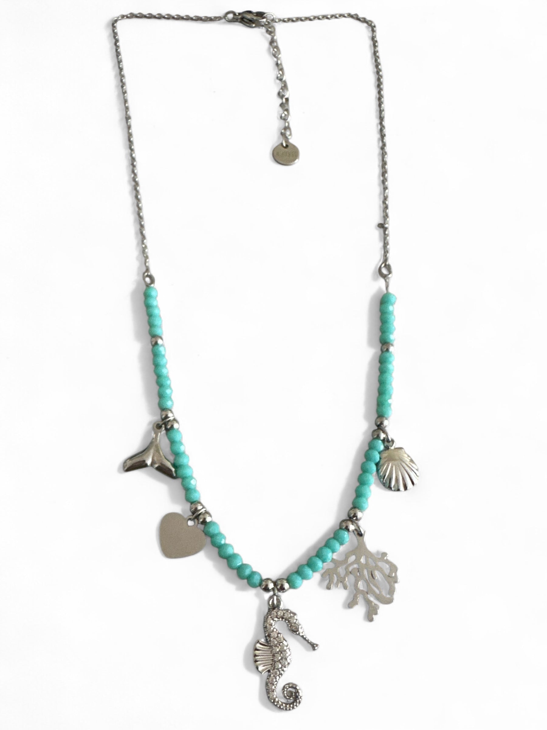Necklace with turquoise beads and silver charms on a white background So Cute by DImi