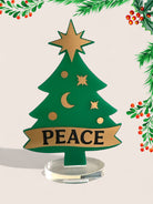 Επιτραπέζιο γούρι Christmas Pop Peace Tree από plexiglass σε σχήμα δέντρου με banner PEACE – So Cute by Dimi