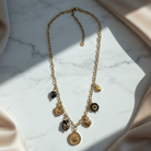 Ατσάλινο κολιέ με χρυσά και μαύρα charms – So Cute by Dimi