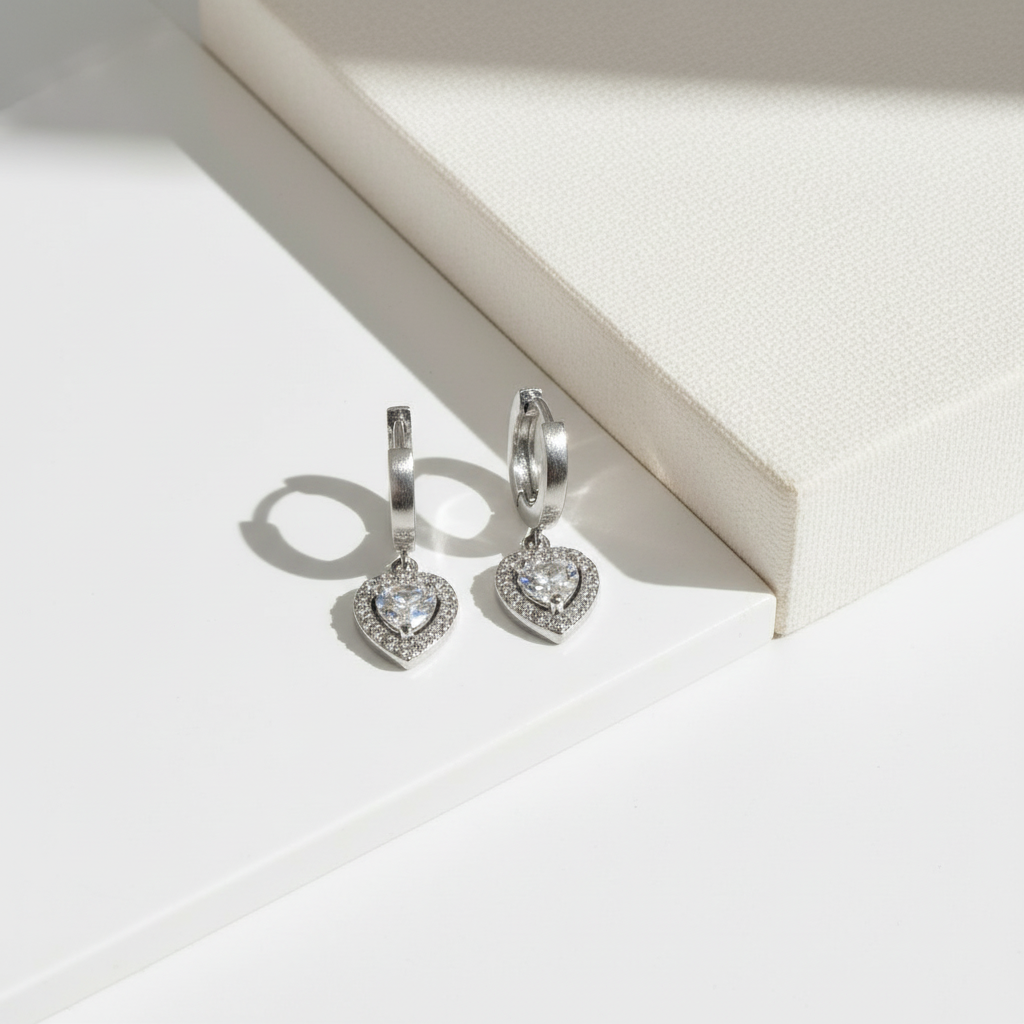 Amor Earrings – Ατσάλινα σκουλαρίκια με κρικάκι και καρδιά με ζιργκόν σε  ασημί | So Cute by Dimi