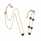 Ατσάλινο κολιέ & βραχιόλι So Cute by Dimi με χρυσή αλυσίδα και τετράφυλλο μοτίφ σε μαύρο ή λευκό φίλντισι