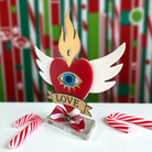 Επιτραπέζιο γούρι Christmas Pop Love Heart από plexiglass με μάτι, φλόγα, φτερά & banner LOVE – So Cute by Dimi